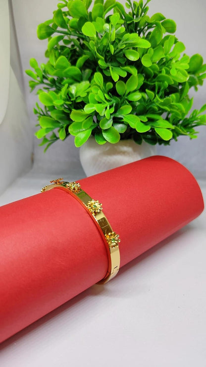 Gold Floral Bloom Bangle with Emerald-Green Accents